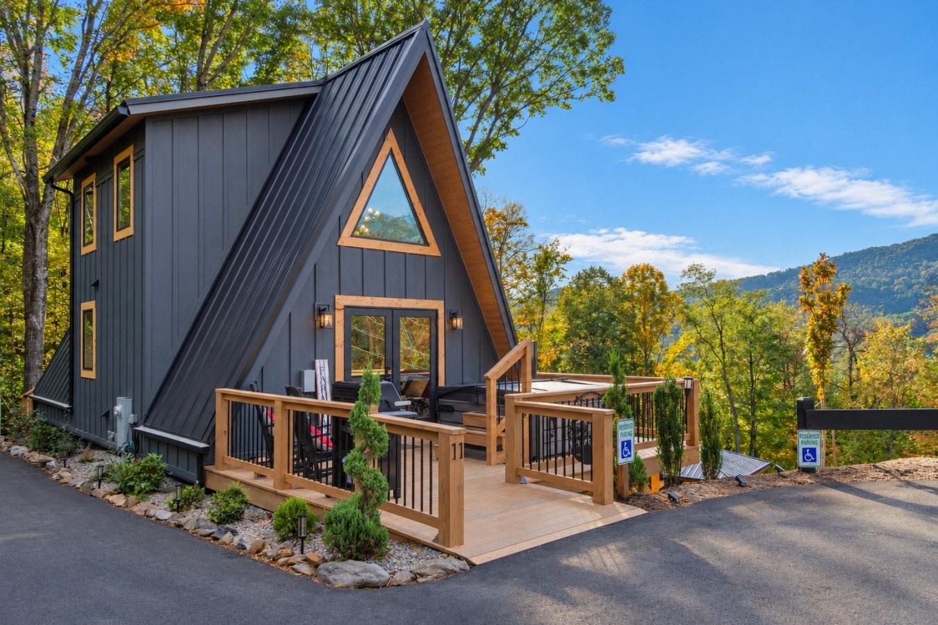 The Farm A-frame cabin in West Jefferson NC with its deck and views toward the mountains.