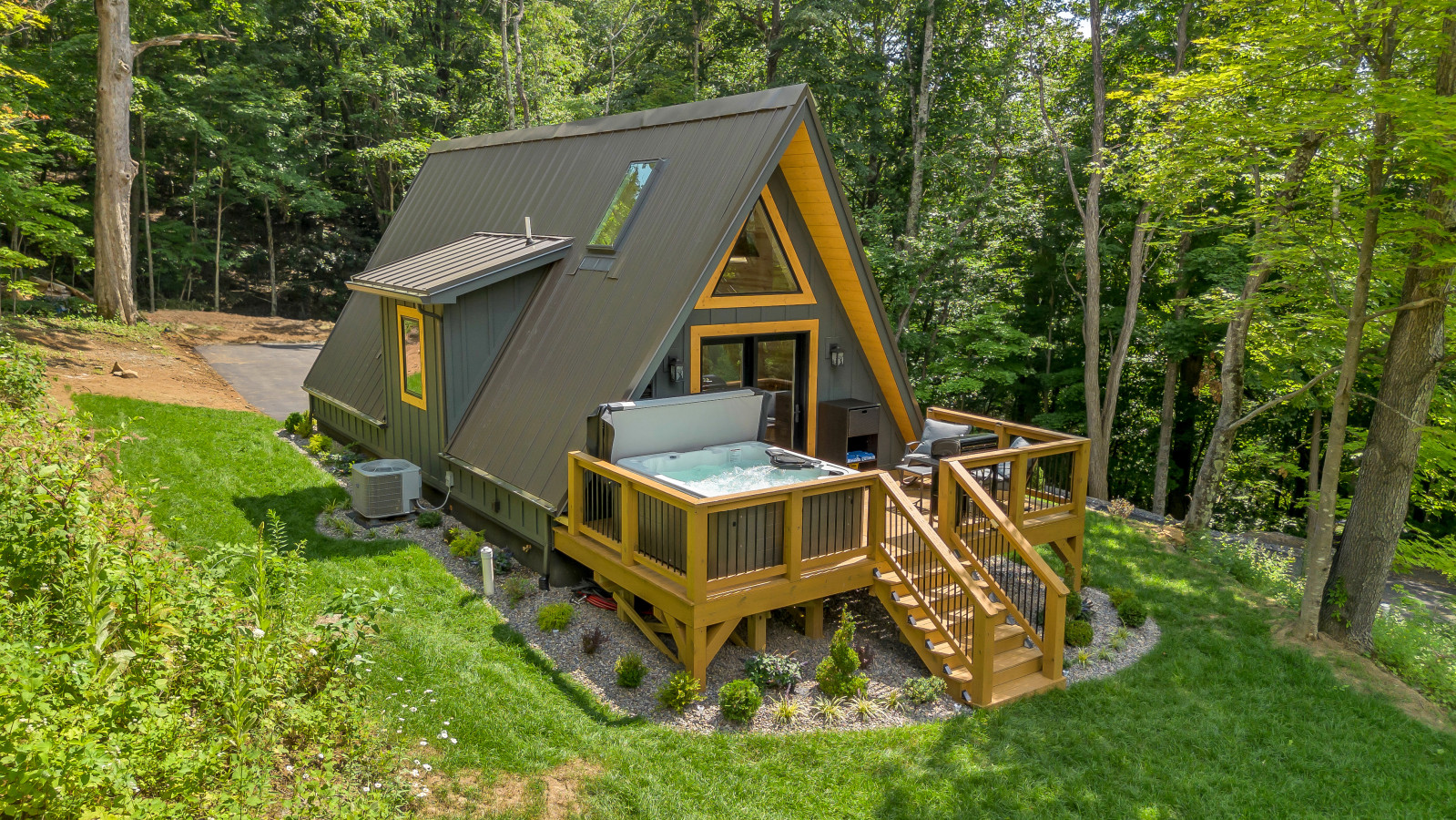 Drone view of High Peak deck, XL hot tub, and forest