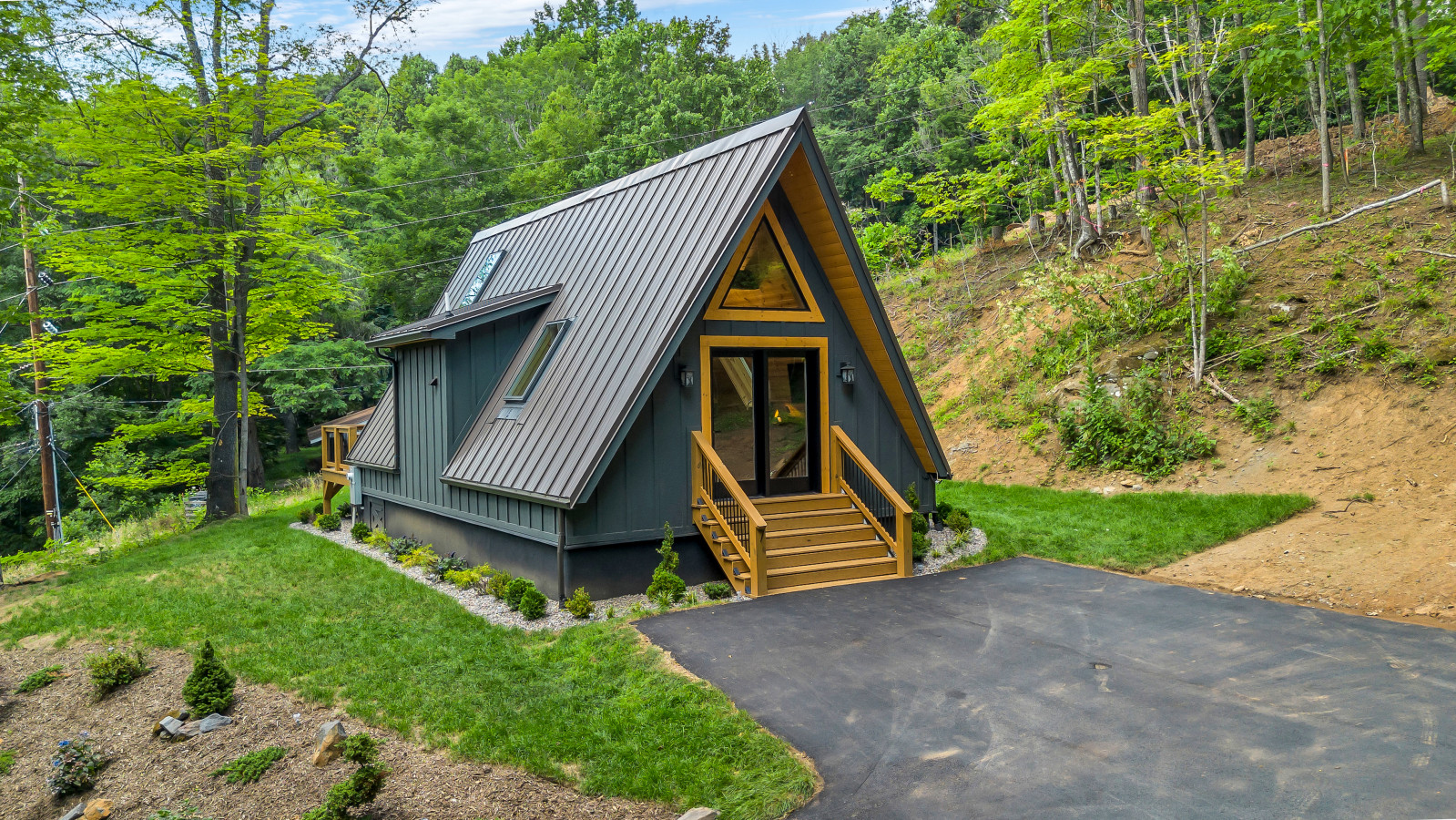 High Peak A-frame on the wooded hillside above the driveway