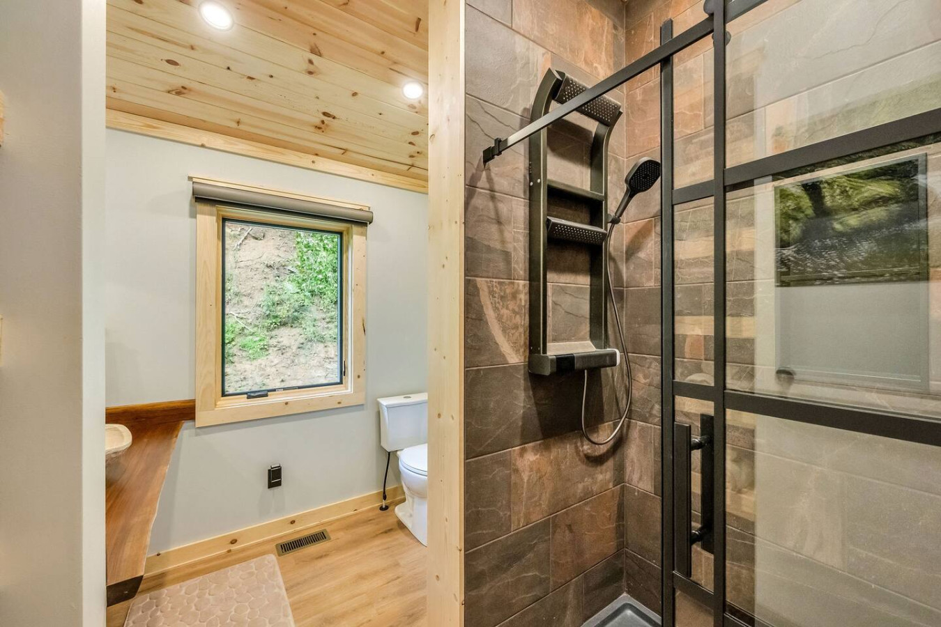 Walk-in tile spa shower with rainfall head, handheld wand, and LED temperature display