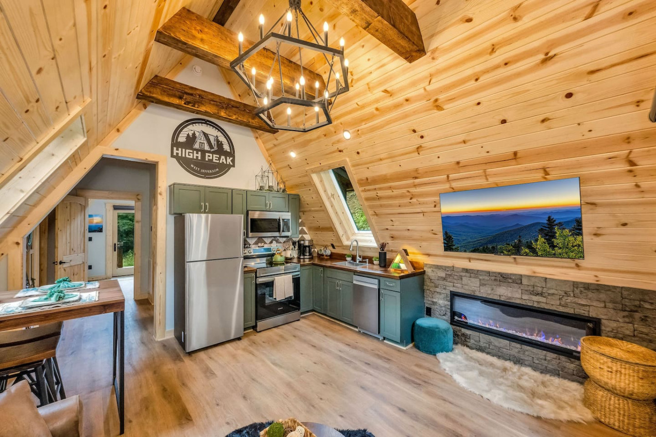 Living area with electric fireplace, Smart TV, and open kitchen