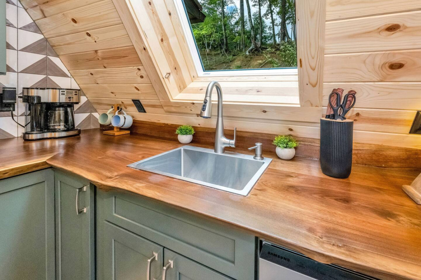 Kitchen sink under the A-frame skylight with live-edge wood counter