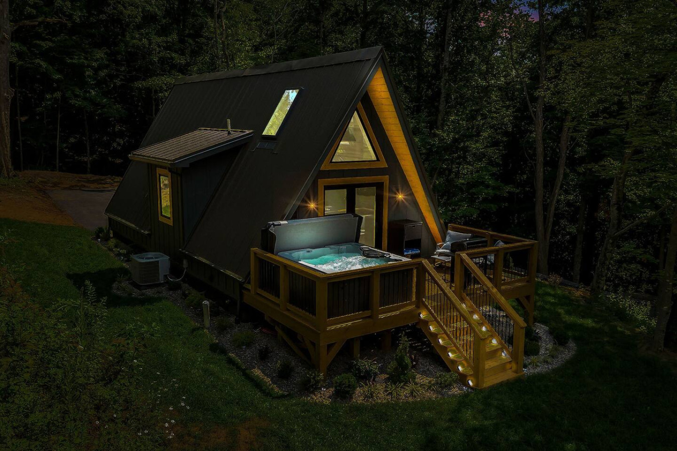 High Peak deck at night with the XL hot tub glowing