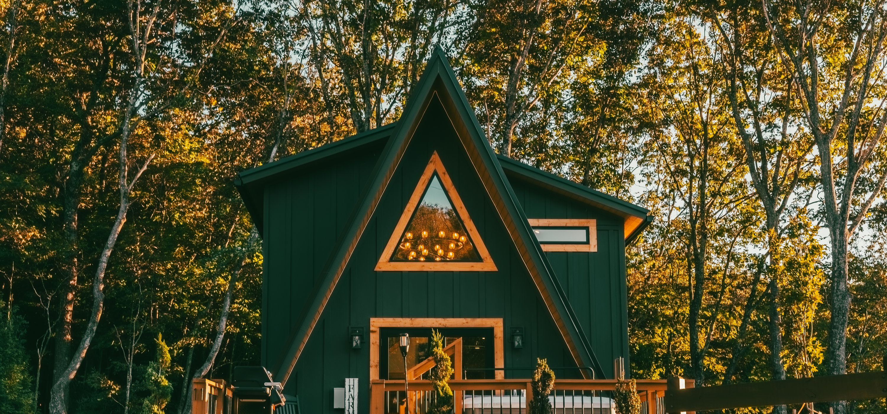 Front of the Farm A-frame cabin in West Jefferson, NC, with a porch grill and hot tub