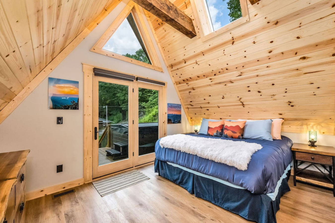 King bedroom looking through glass doors to the deck hot tub